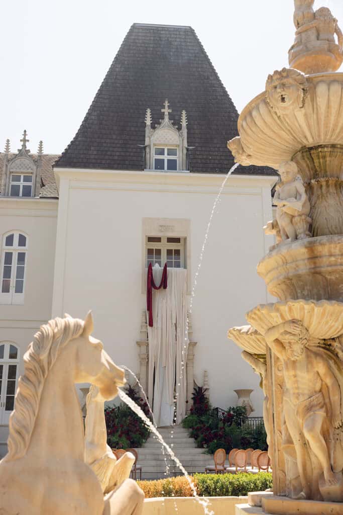 Burgundy and ivory French chateau wedding editorial at Chateau Nouvelle, designed by Épris Events – photo by Emily Snyder Photography